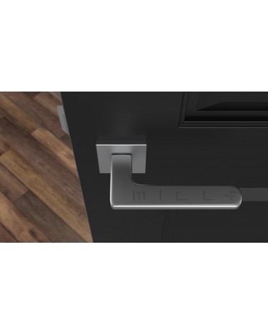 Poignée de porte chrome satiné YUKA quincaillerie design vue de haut montée sur une porte