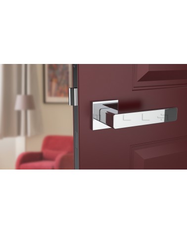 Poignée de porte chrome poli ERICA quincaillerie design vue de face montée sur une porte