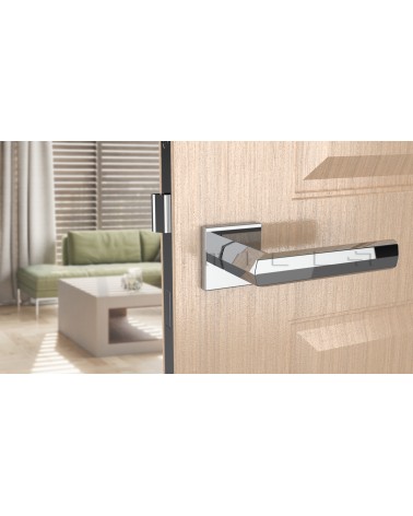Poignée de porte chrome poli FRESIA poignée design vue de face montée sur une porte