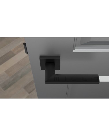 Poignée de porte noire PYROLA quincaillerie design vue de haut montée sur une porte