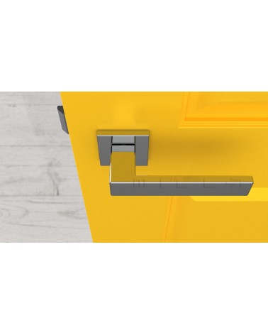 Poignée de porte chrome poli PINA poignée design vue de haut montée sur une porte