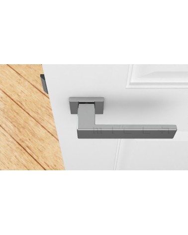 Poignée de porte chrome poli PINA poignée design vue de haut montée sur une porte