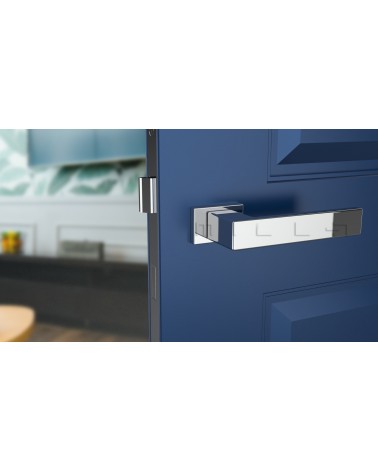 Poignée de porte chrome poli PINA poignée design vue de face montée sur une porte