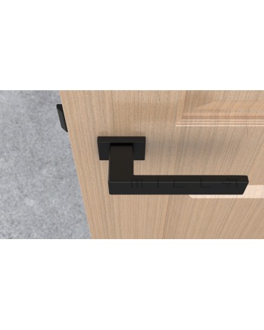 Poignée de porte noire PINA poignée design vue de haut montée sur une porte