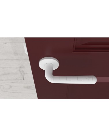 Poignée de porte blanche mate IRGA poignée design vue de haut montée sur une porte