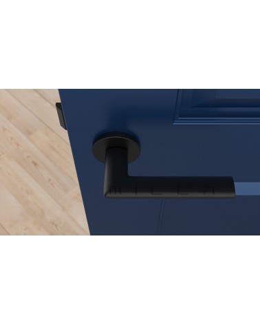 Poignée de porte noire KALMIA poignée design vue de haut montée sur une porte