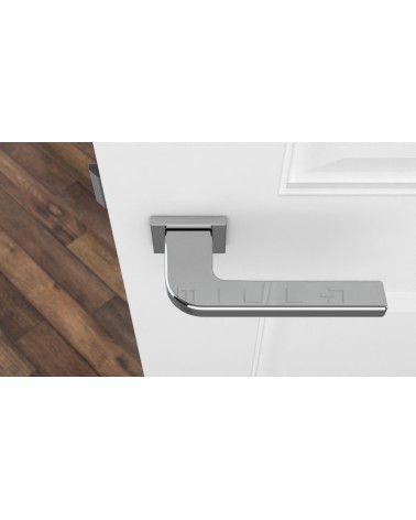Poignée de porte chrome poli ISMENA quincaillerie design vue de haut montée sur une porte