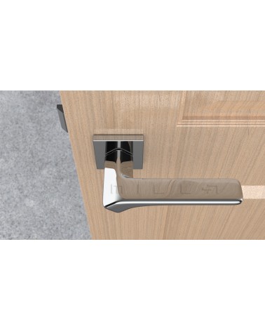 Poignée de porte chrome poli BERGERIA quincaillerie design vue de haut montée sur une porte