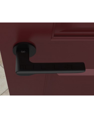Poignée de porte noire LIGNE poignée design vue de haut montée sur une porte
