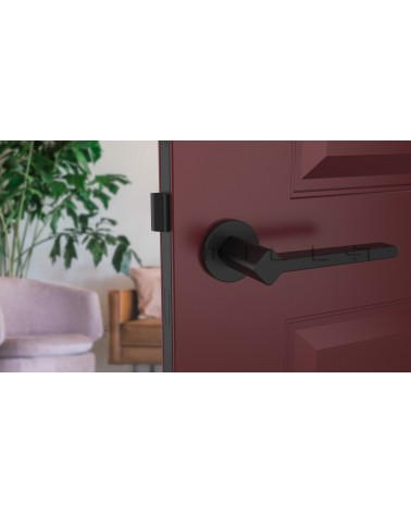 Poignée de porte sur plaque ronde NINFEA quincaillerie design montée sur une porte entrouverte