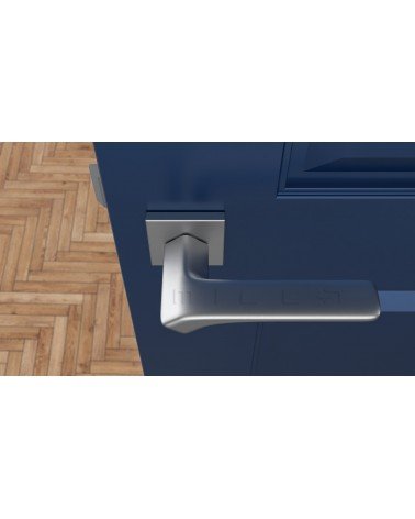 Poignée de porte chrome satiné BERGERIA quincaillerie design vue de haut montée sur une porte