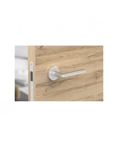 Poignée de porte chrome satiné Spark poignée design vue de haut montée sur une porte